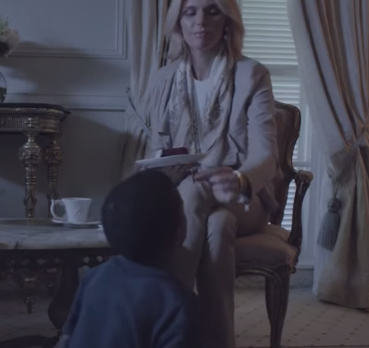 Watch this ad where a white lady treats this little black boy like a puppy